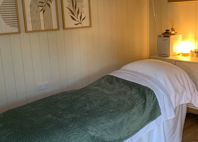 Relaxing spa treatment room at Botanical Beauty in Swadlincote, England, GB, featuring ambient lighting.