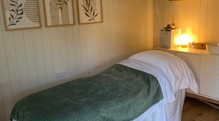 Relaxing spa treatment room at Botanical Beauty in Swadlincote, England, GB, featuring ambient lighting.