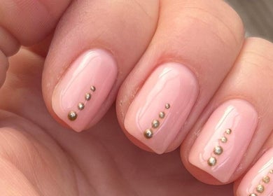 Pink manicured nails with gold accents at Botanical Beauty, Swadlincote, England, GB.