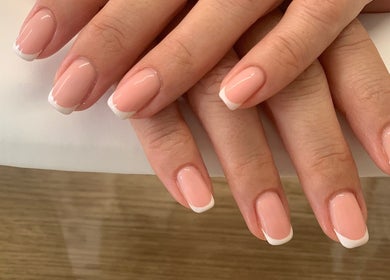 Elegant French manicure at Botanical Beauty, Swadlincote, England, GB. Perfectly groomed nails with a glossy finish.