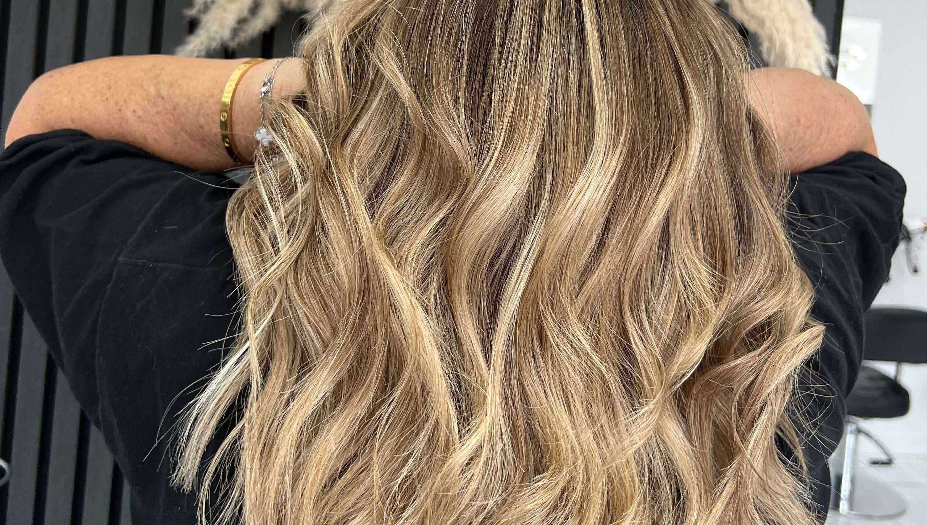 Blonde wavy hairstyle at KHD in Newtongrange, Scotland, GB showcasing vibrant highlights.