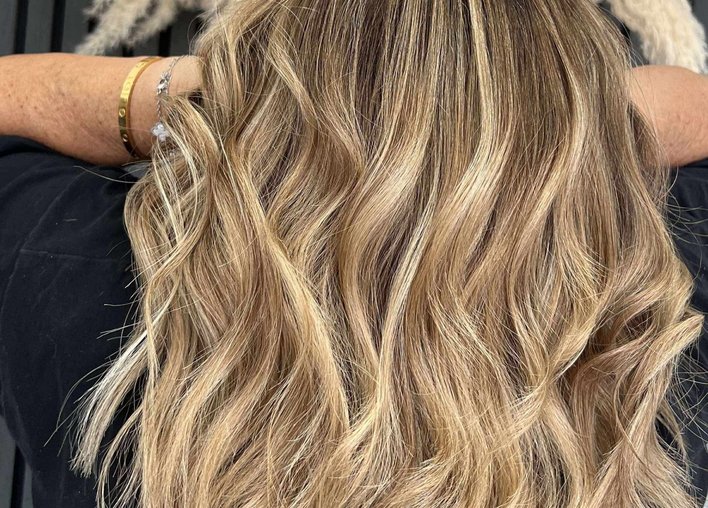 Blonde wavy hairstyle at KHD in Newtongrange, Scotland, GB showcasing vibrant highlights.