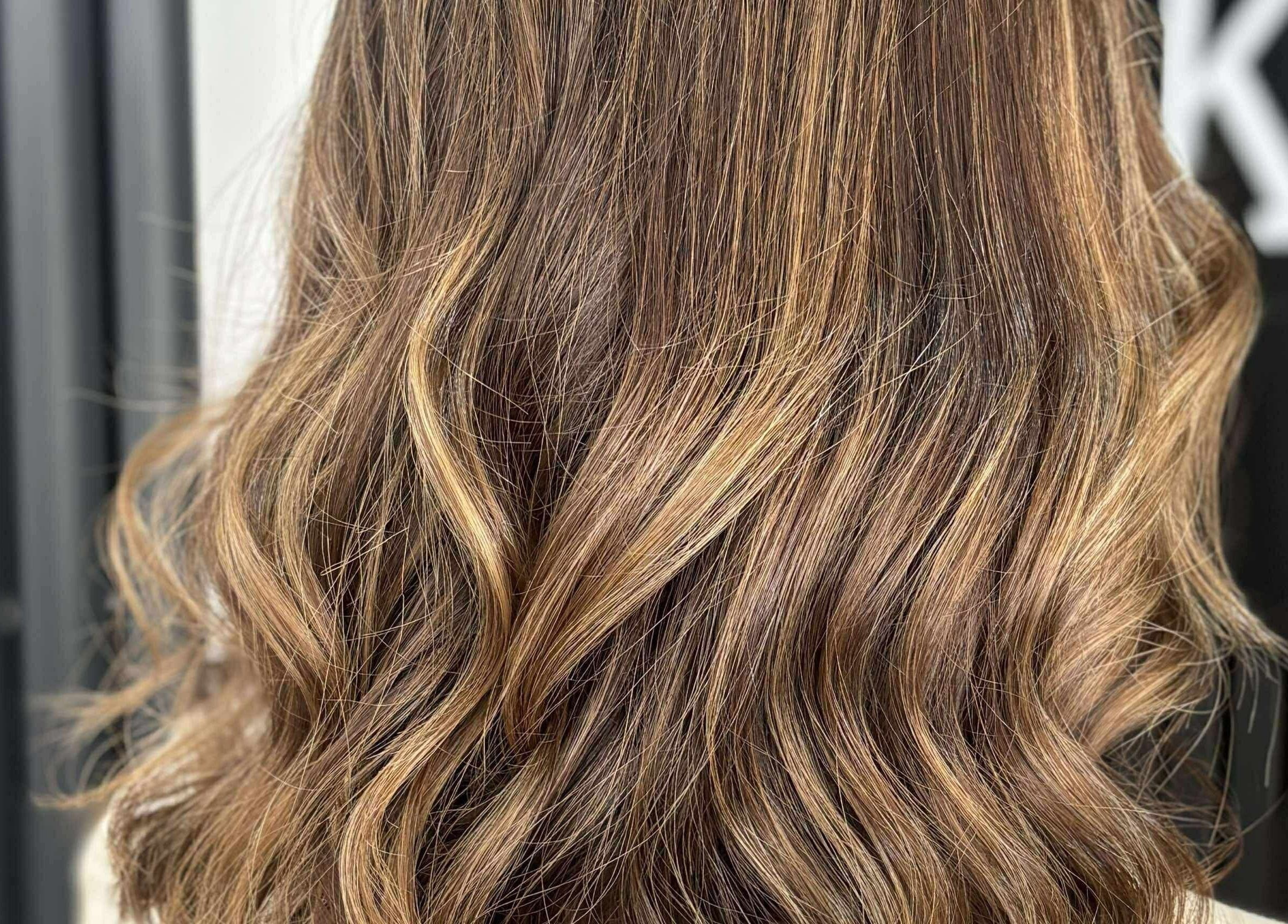 Elegant wavy hairstyle at KHD in Newtongrange, Scotland, GB showcasing warm golden tones.