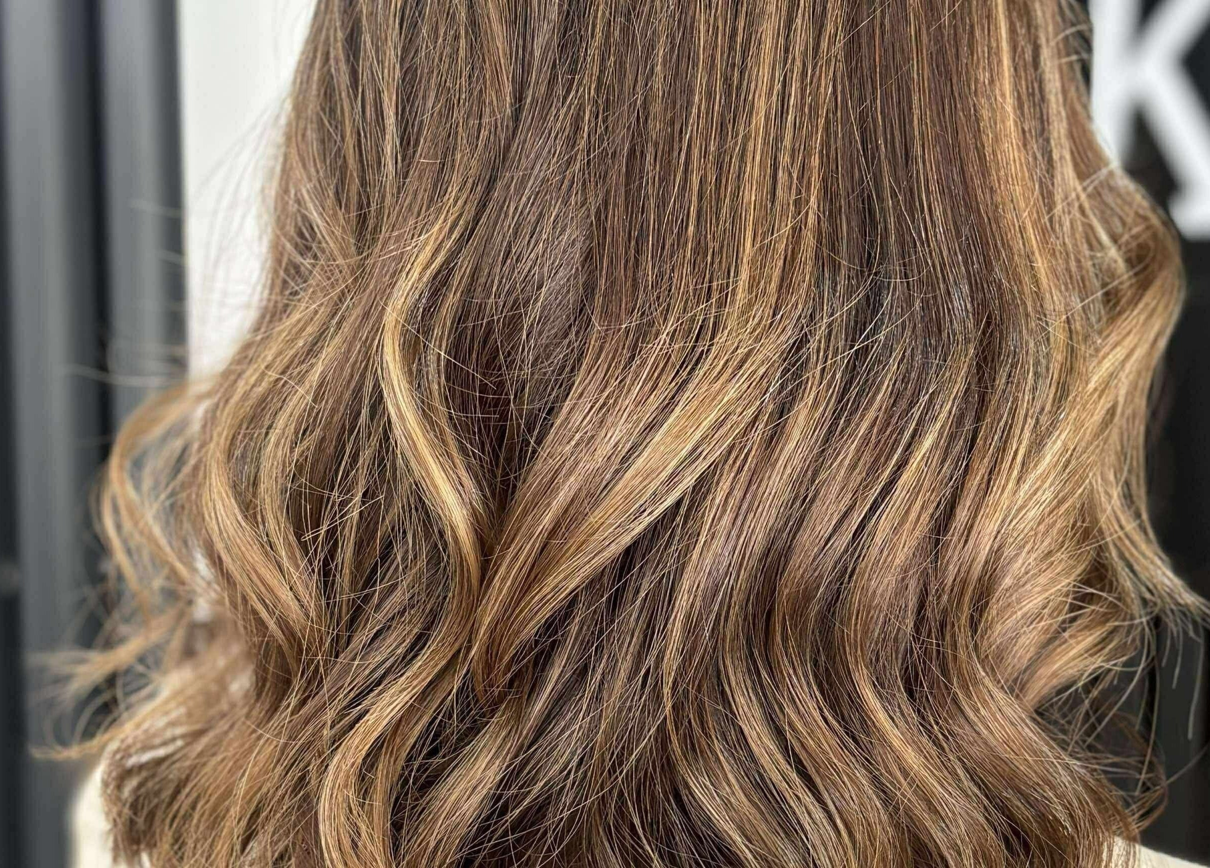 Elegant wavy hairstyle at KHD in Newtongrange, Scotland, GB showcasing warm golden tones.