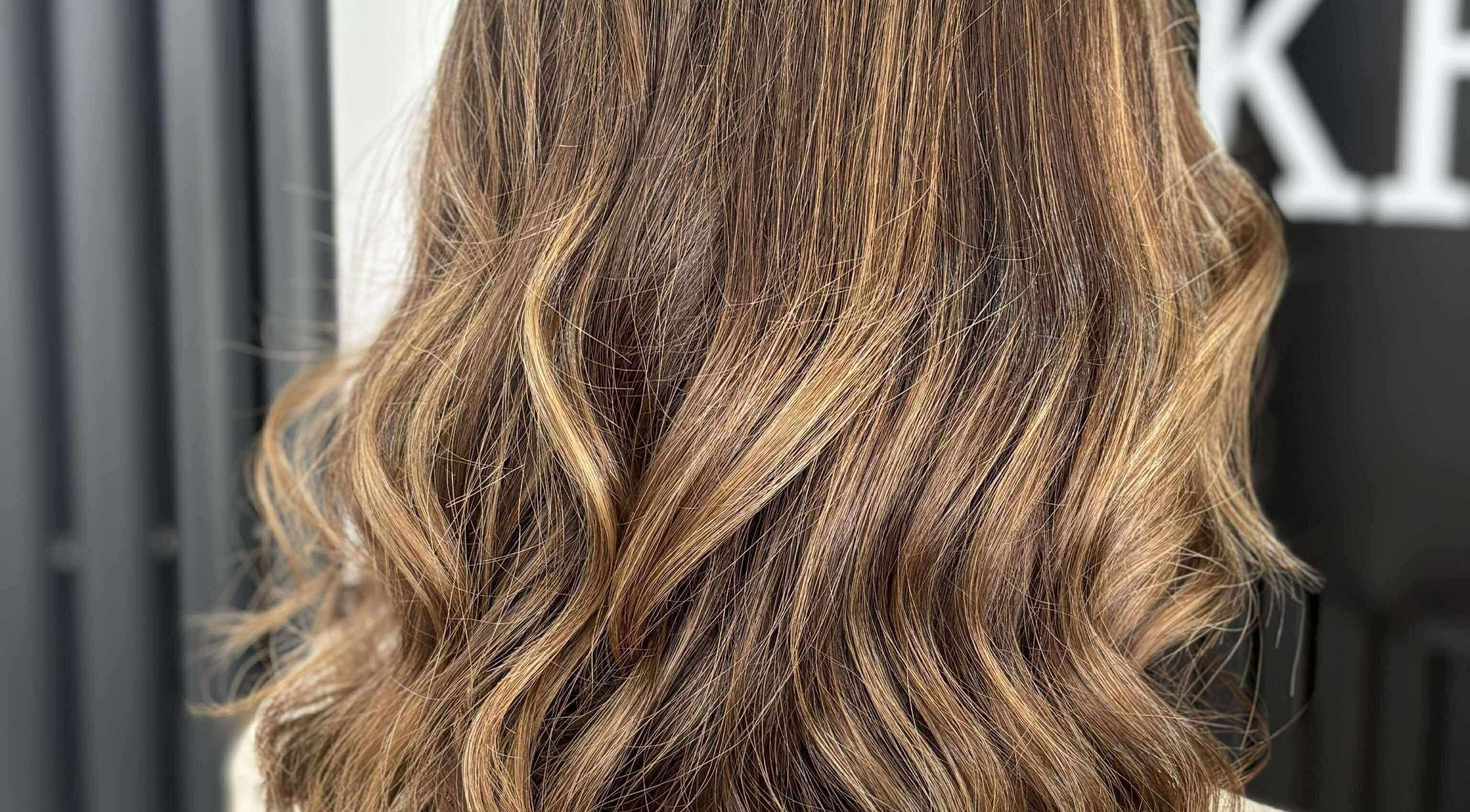 Elegant wavy hairstyle at KHD in Newtongrange, Scotland, GB showcasing warm golden tones.