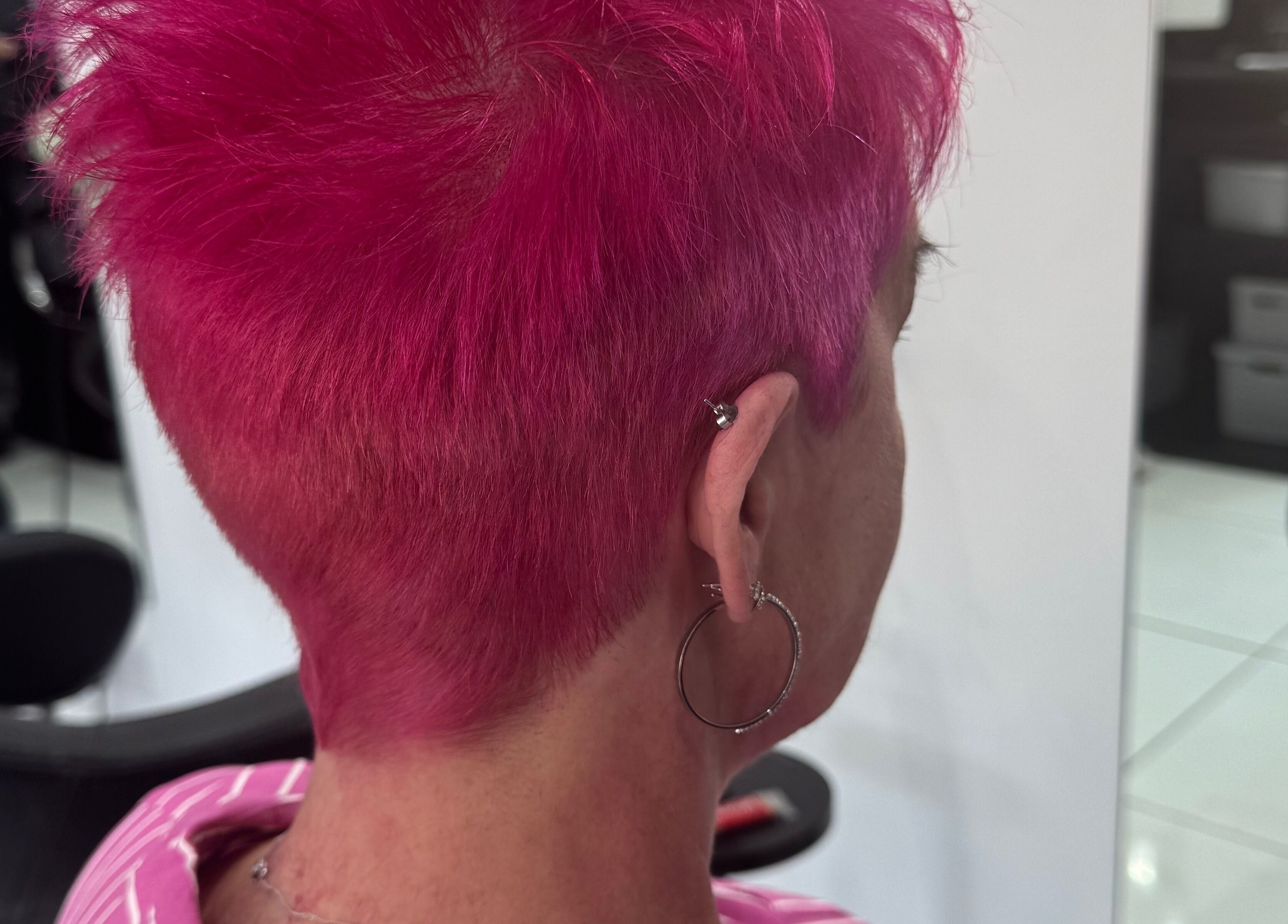 Bright pink pixie cut hairstyle at KHD in Newtongrange, Scotland, GB, showcasing modern salon style.
