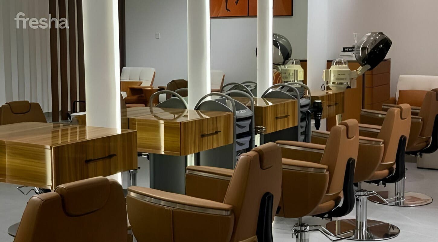 Saras Beauty Lounge in Dubai, Dubai, AE showcases a modern salon interior with sleek styling chairs and equipment.