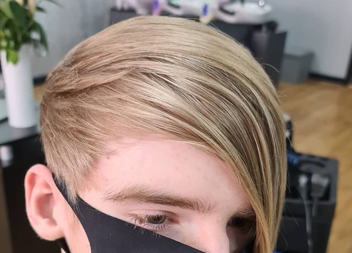 Chic layered haircut at Total Eclipse Hair and Beauty, Litherland, England, GB. Modern style with sleek blonde finish.