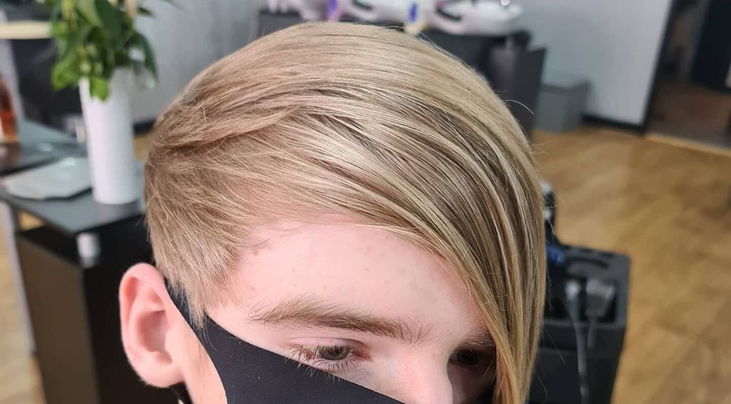 Chic layered haircut at Total Eclipse Hair and Beauty, Litherland, England, GB. Modern style with sleek blonde finish.