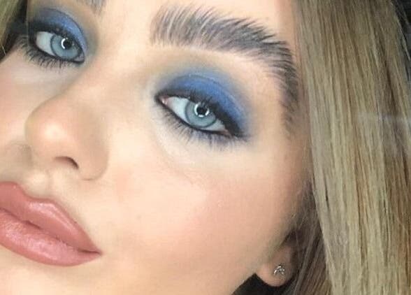 Close-up of bold blue eye makeup at Total Eclipse Hair and Beauty in Litherland, England, GB.