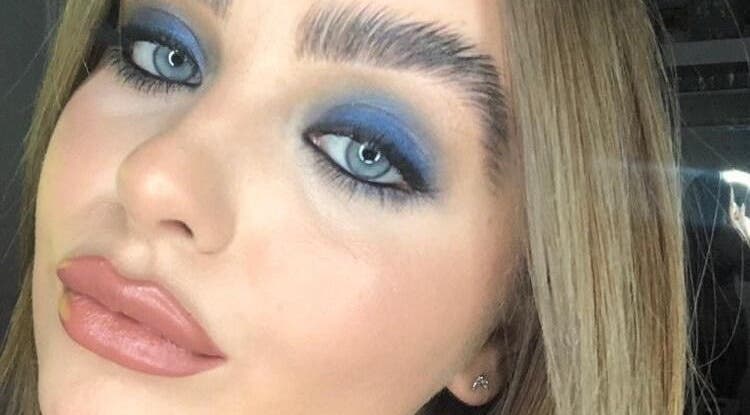Close-up of bold blue eye makeup at Total Eclipse Hair and Beauty in Litherland, England, GB.