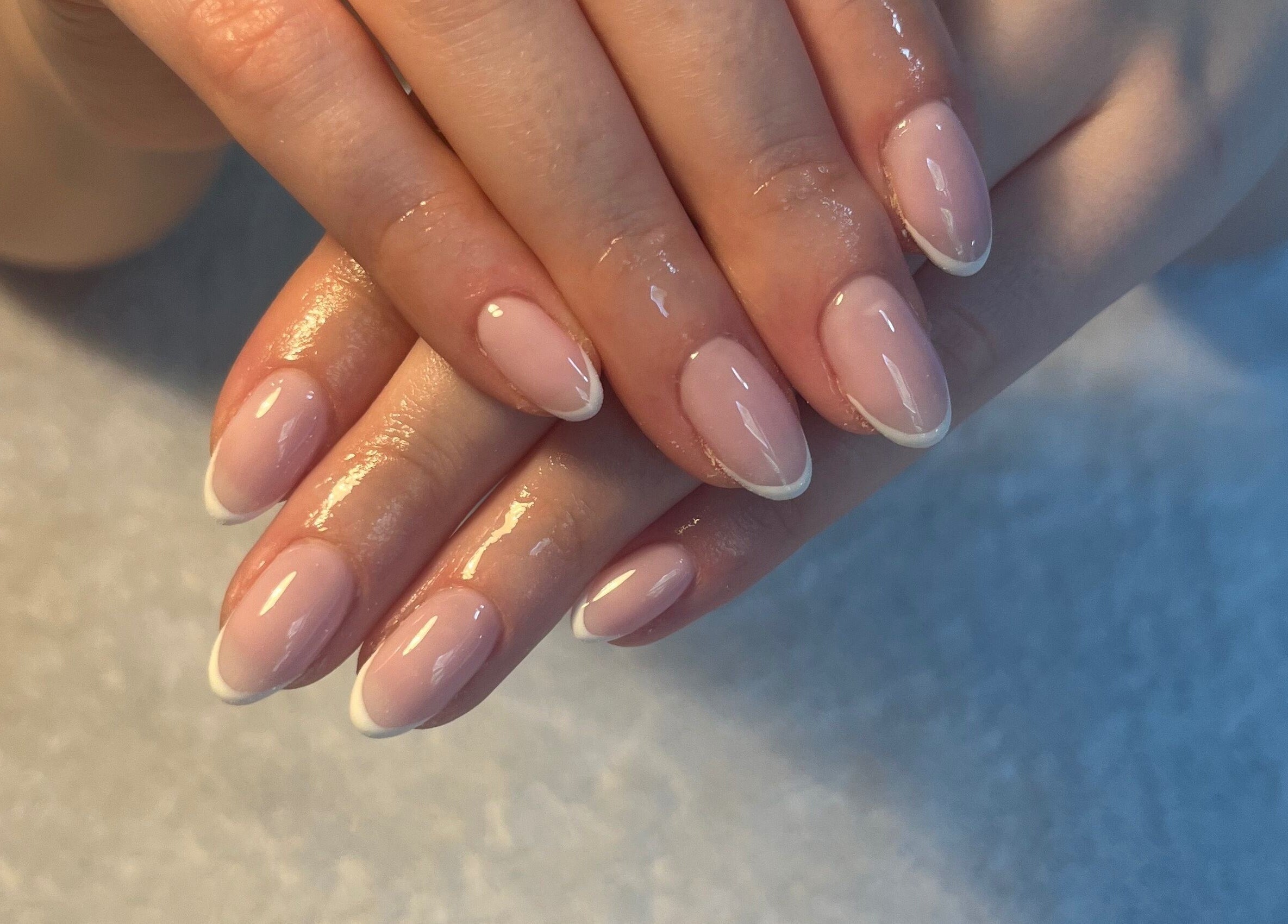 Freshly manicured hands at SC Beauty, Limerick, County Limerick, IE, showcasing glossy French tips.
