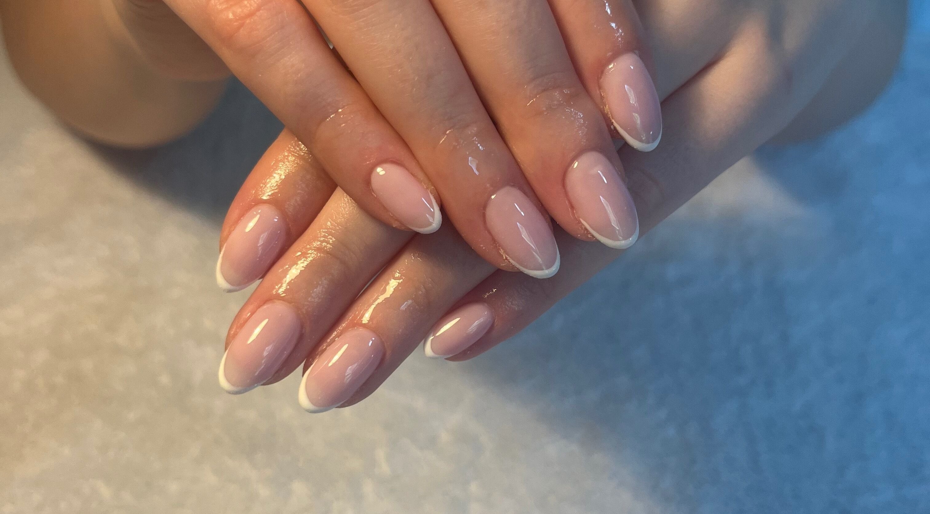 Freshly manicured hands at SC Beauty, Limerick, County Limerick, IE, showcasing glossy French tips.