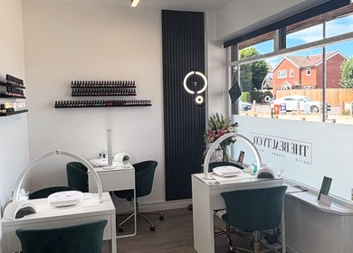 The Beauty Co. salon interior with manicure stations in Rugby, England, GB, featuring elegant decor.