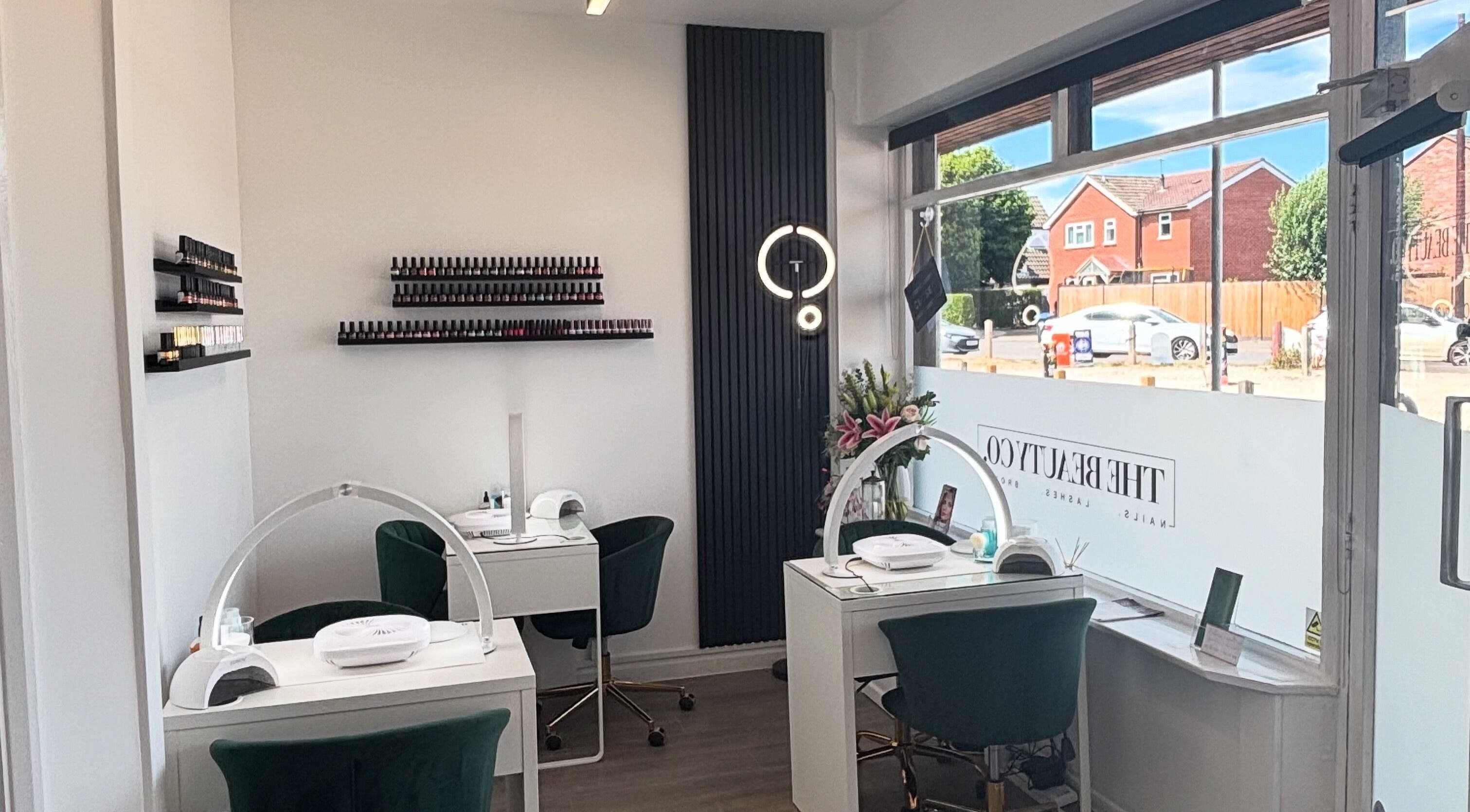 The Beauty Co. salon interior with manicure stations in Rugby, England, GB, featuring elegant decor.