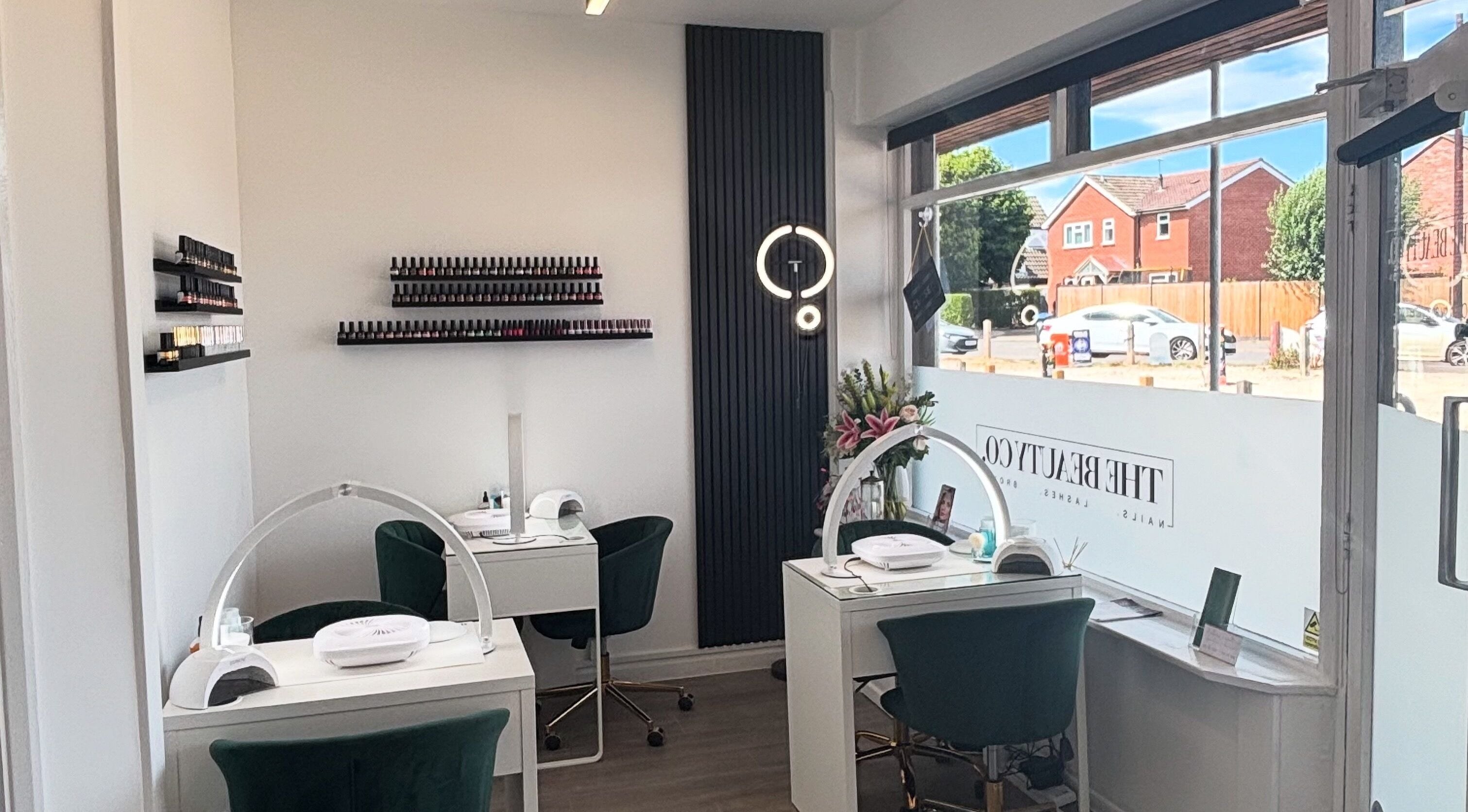 The Beauty Co. salon interior with manicure stations in Rugby, England, GB, featuring elegant decor.