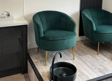 Luxurious green velvet chairs at The Beauty Co. in Rugby, England for a relaxing beauty experience.