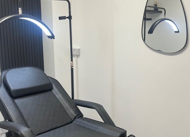 Modern treatment room at The Beauty Co., Rugby, England, GB featuring sleek chair and ambient lighting.