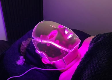 Client experiencing LED facial light therapy at The Beauty Co., Rugby, England, GB.