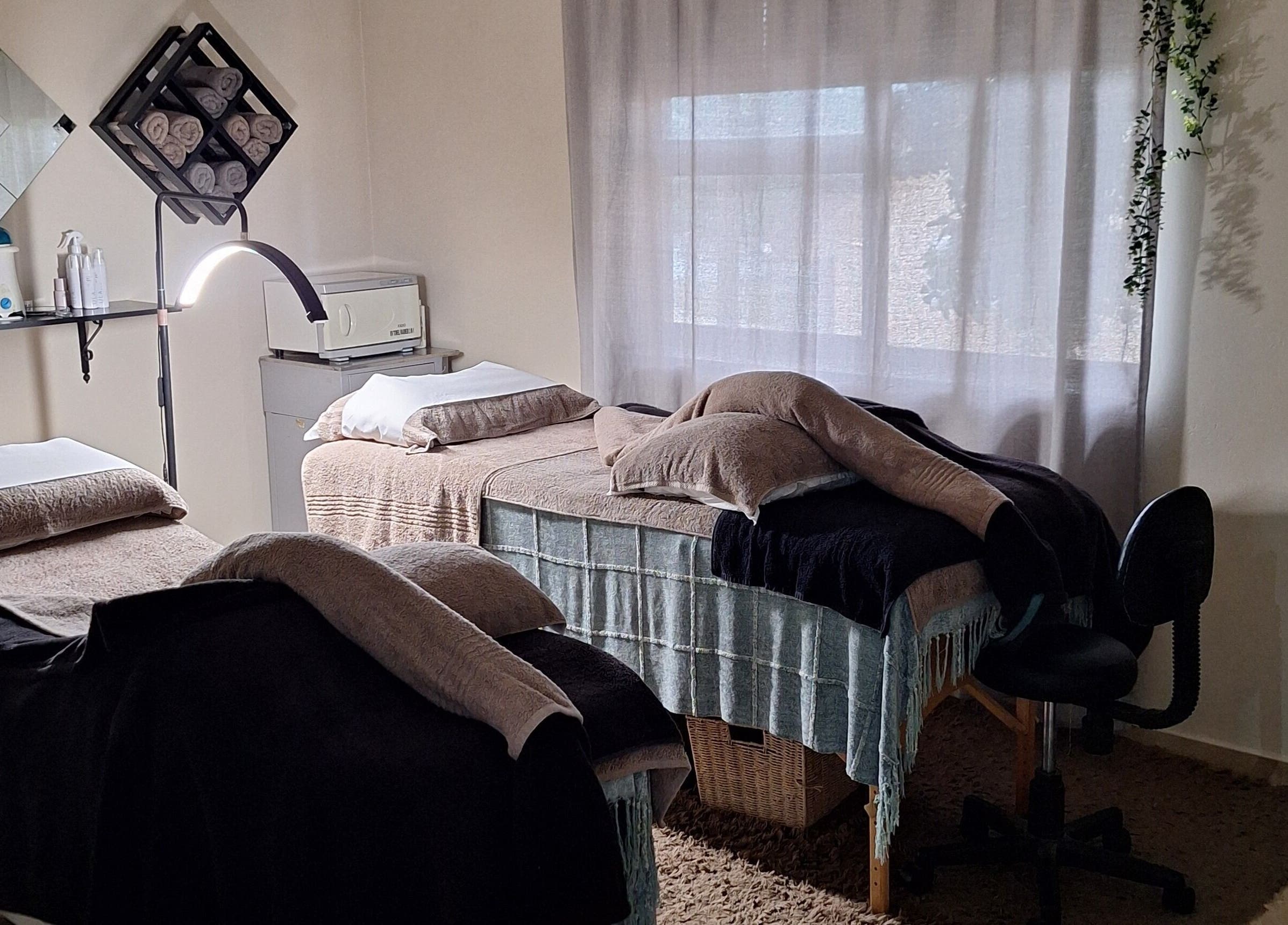 Relaxing treatment room at Arukah Skin & Beauty, Paarl, Western Cape, ZA, featuring two massage beds.