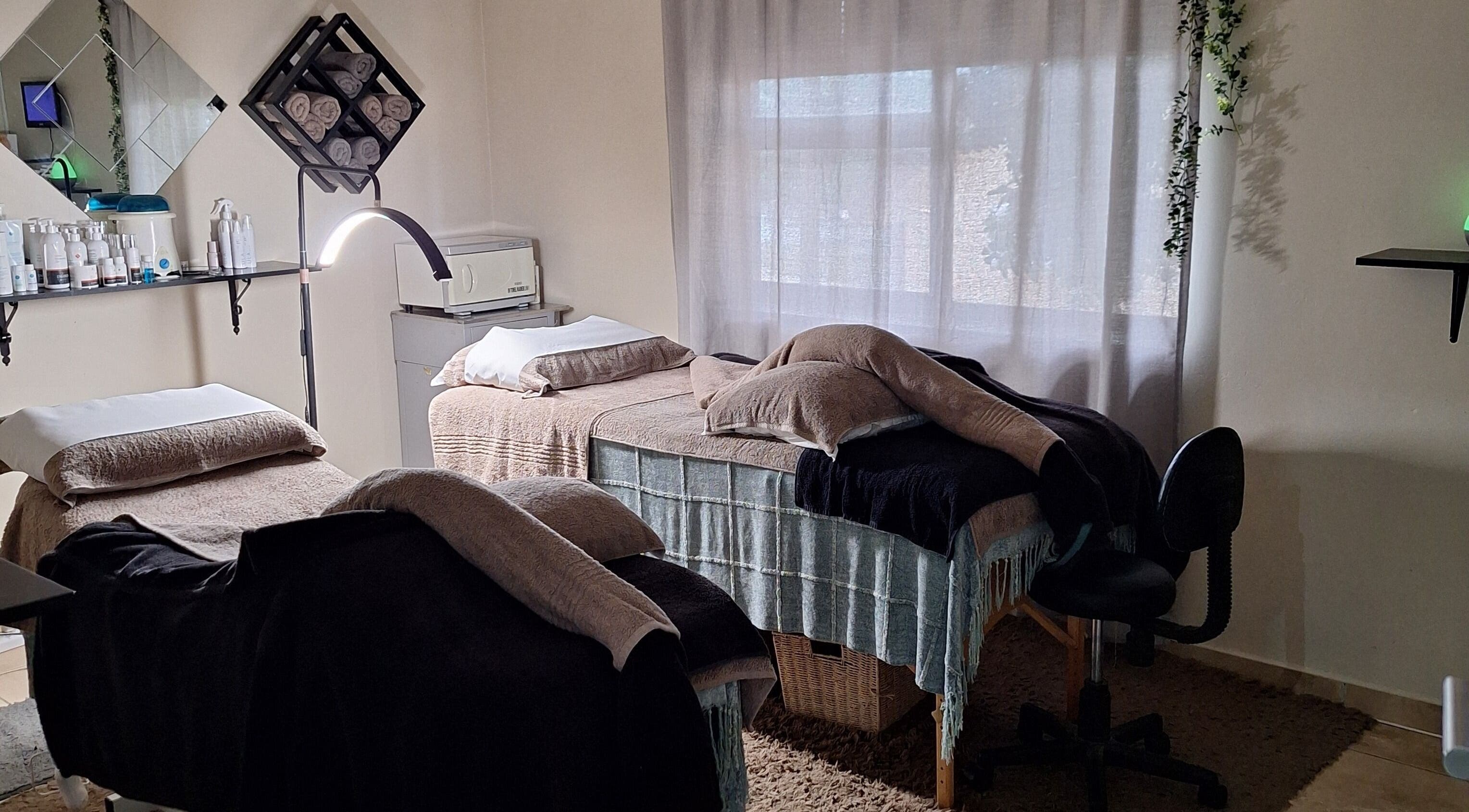 Relaxing treatment room at Arukah Skin & Beauty, Paarl, Western Cape, ZA, featuring two massage beds.