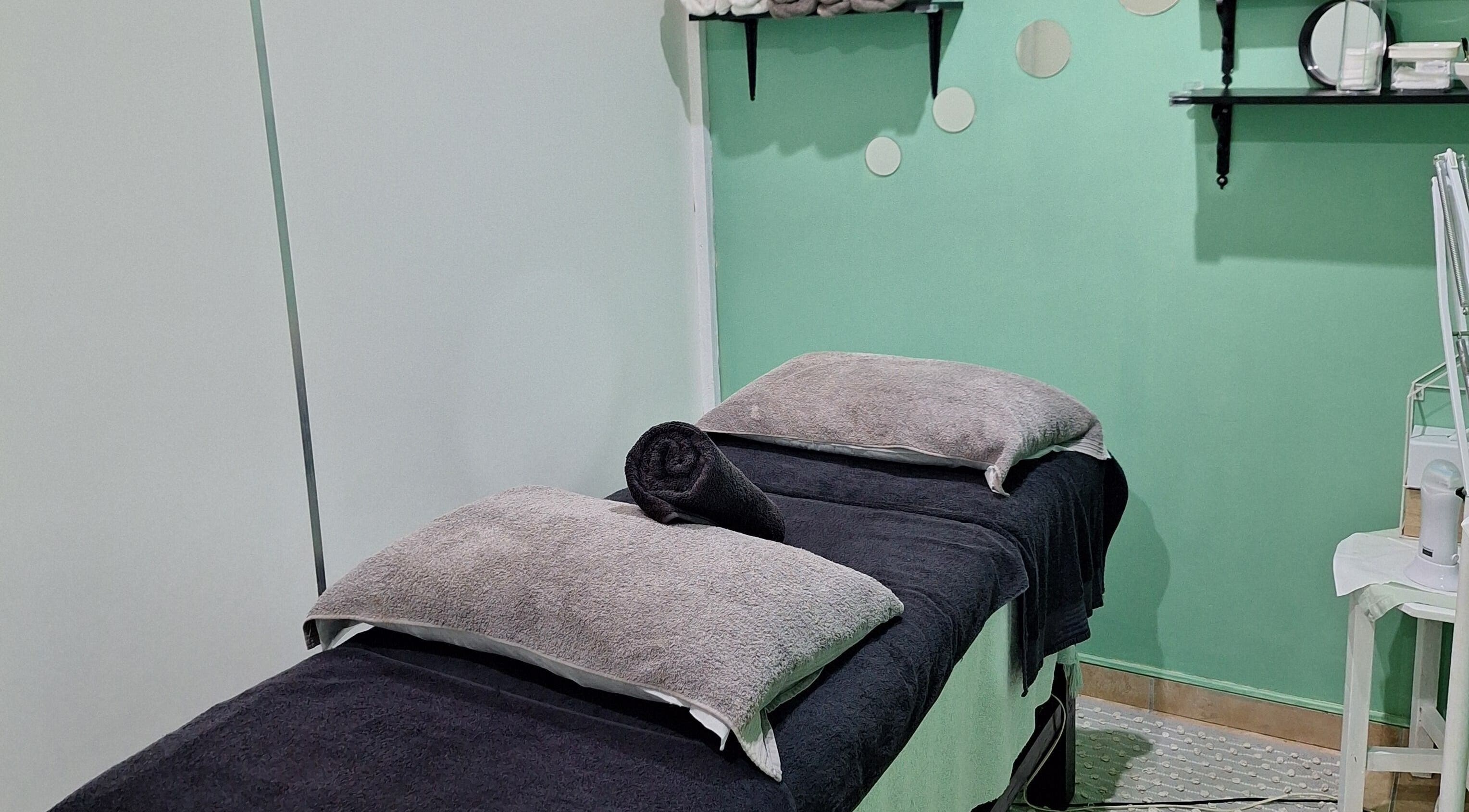 Relaxing treatment room at Arukah Skin & Beauty in Paarl, Western Cape, ZA with calming decor and cozy linens.