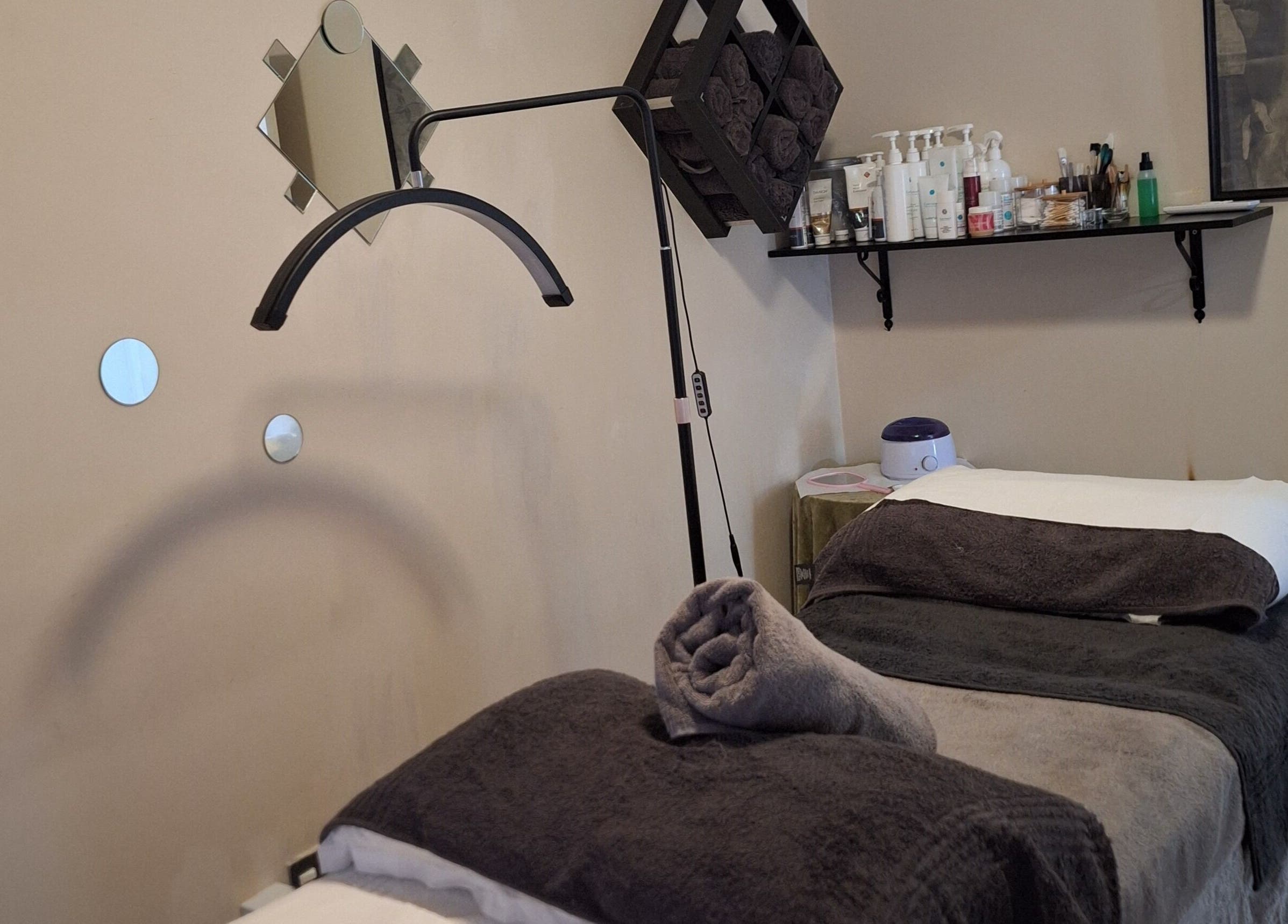 Relaxing treatment room at Arukah Skin & Beauty, Paarl, Western Cape, ZA, featuring massage tables and pampering essentials.