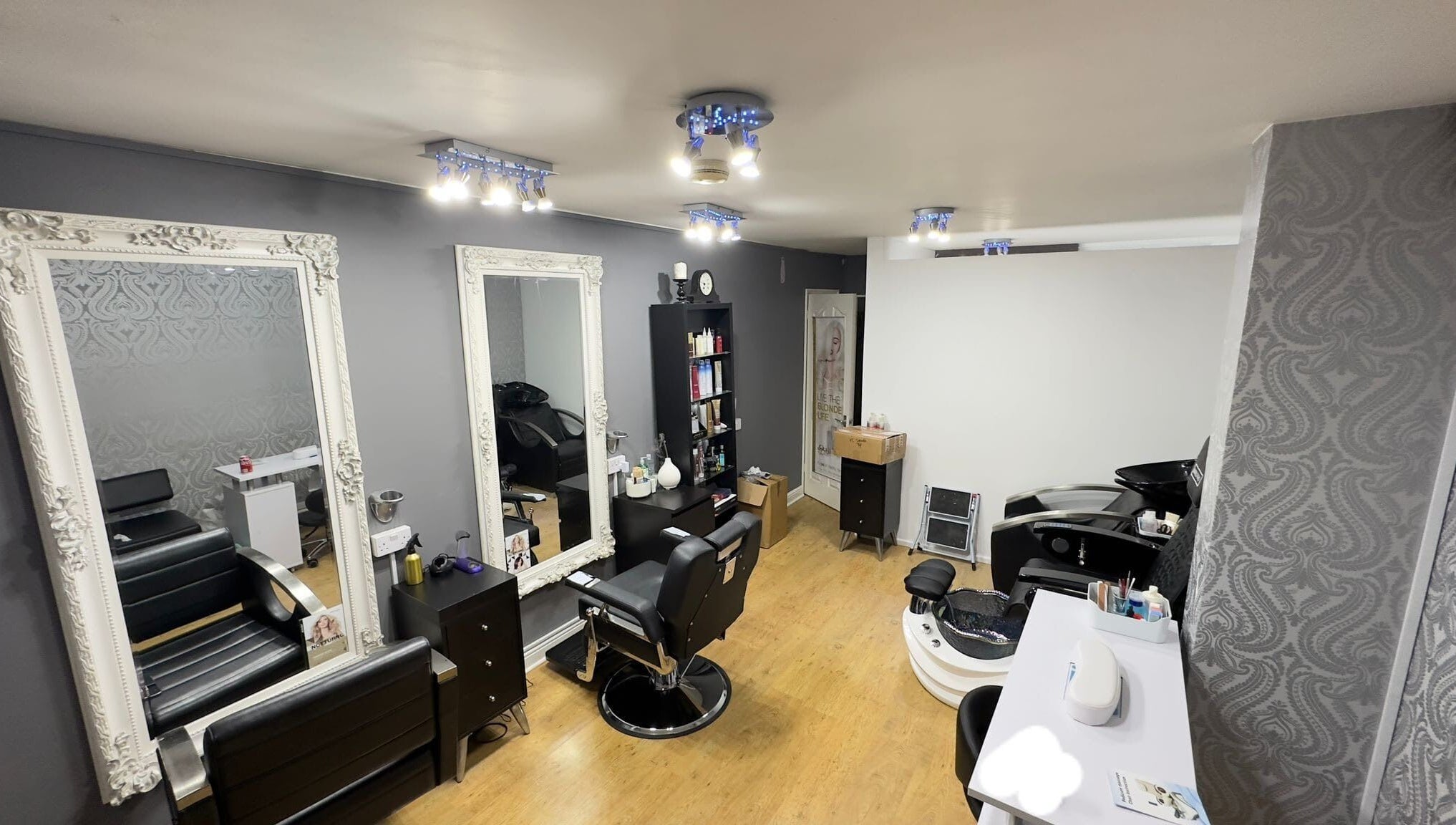 Chic salon interior of Glow Beauty Works in Dartford, England, GB with stylish seating and elegant mirrors.
