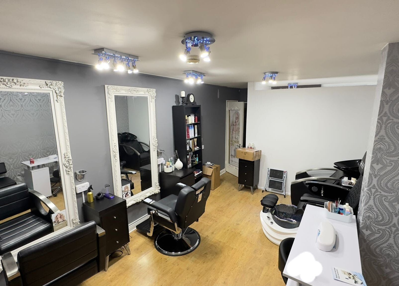 Chic salon interior of Glow Beauty Works in Dartford, England, GB with stylish seating and elegant mirrors.