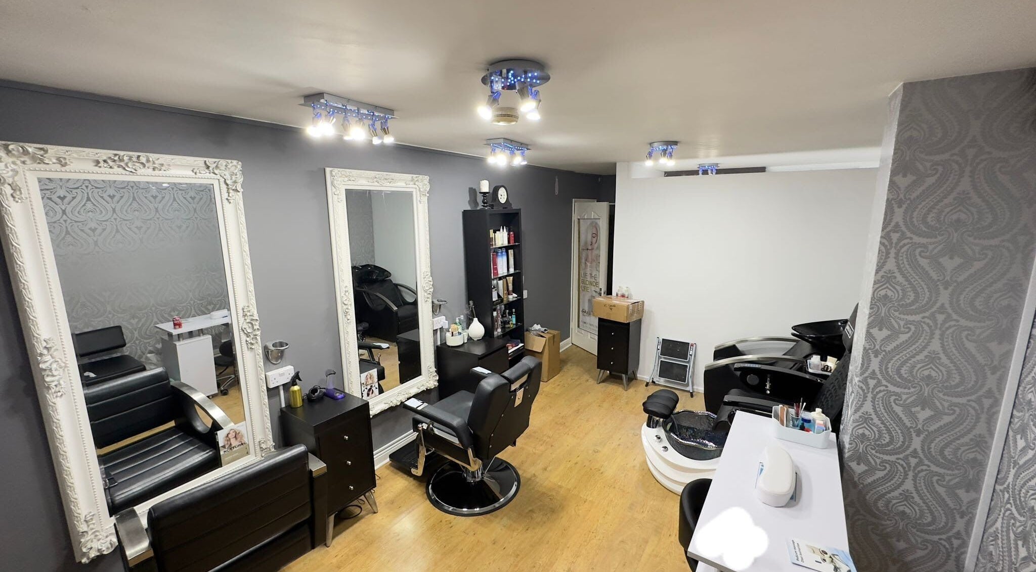 Chic salon interior of Glow Beauty Works in Dartford, England, GB with stylish seating and elegant mirrors.