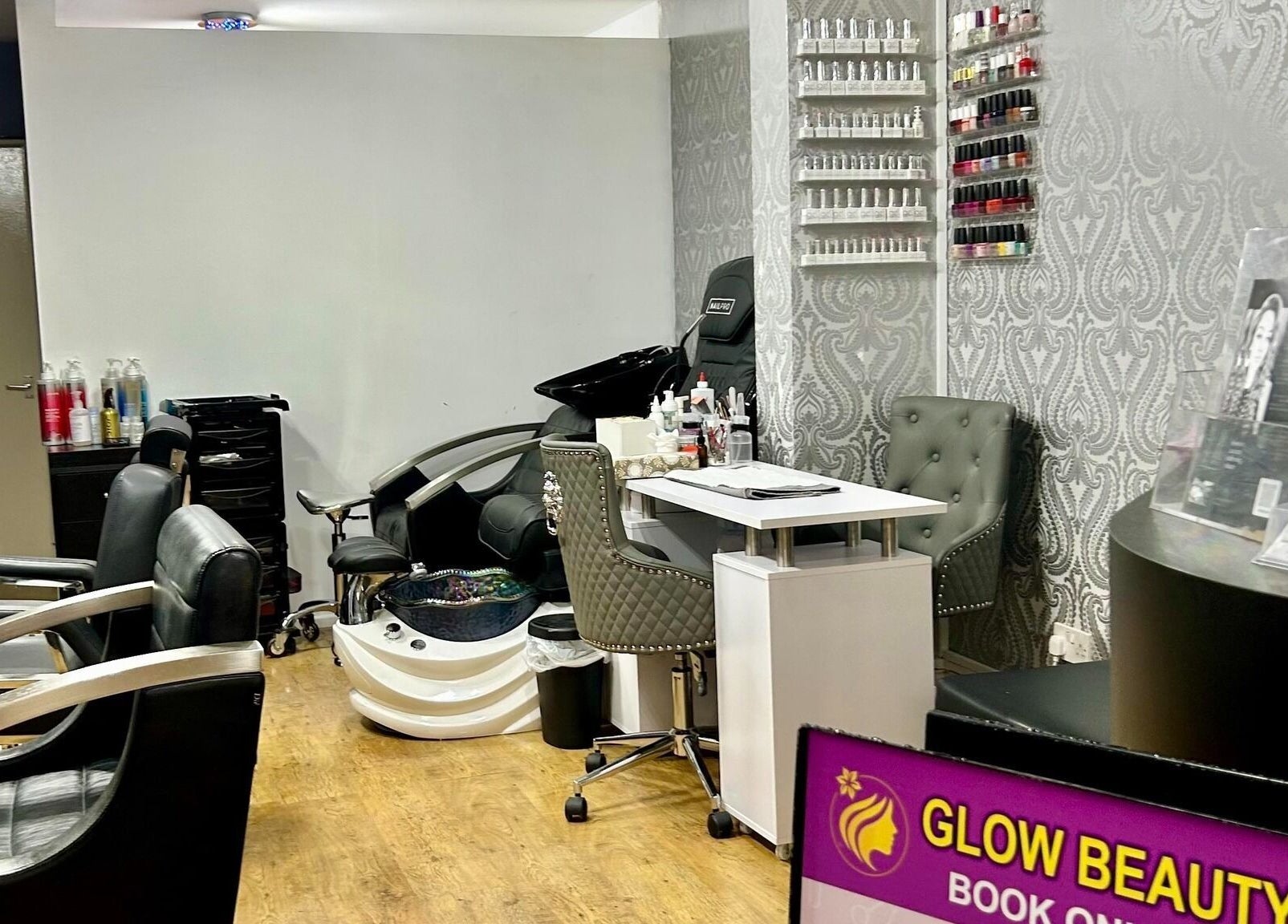 Stylish salon chairs and nail polish display at Glow Beauty Works, Dartford, England, GB.
