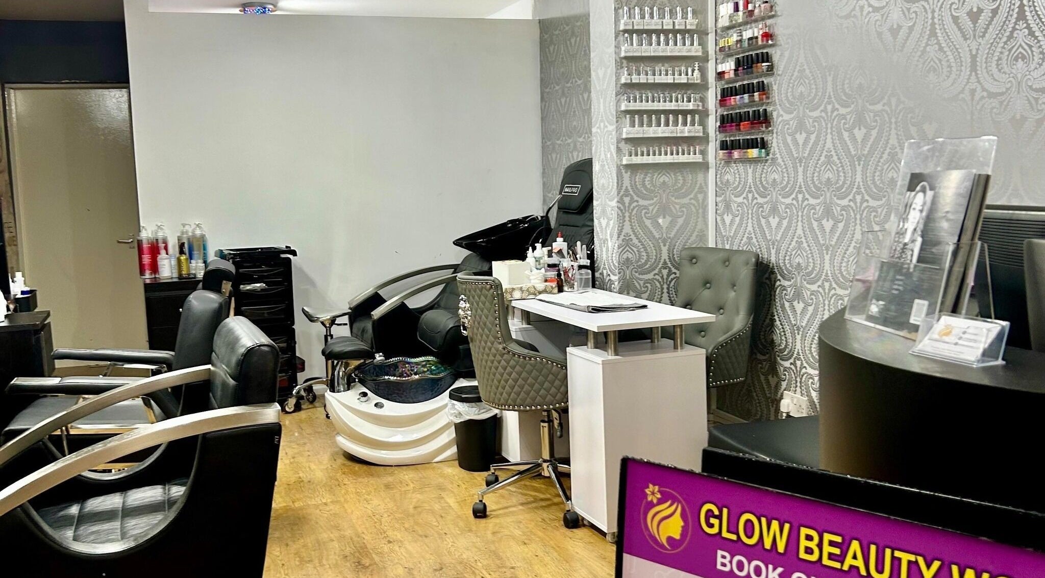 Stylish salon chairs and nail polish display at Glow Beauty Works, Dartford, England, GB.