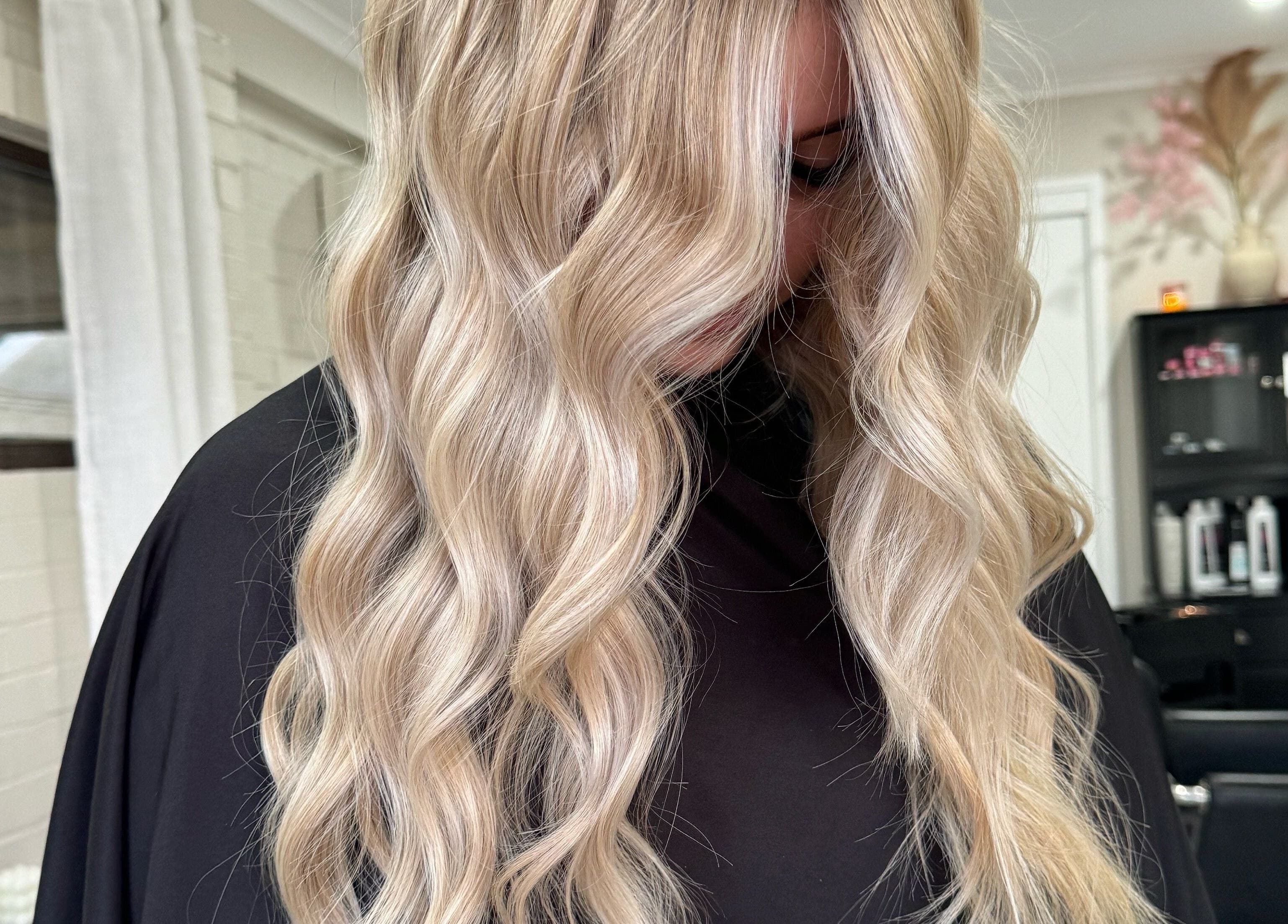 Blonde hair styled in waves at Colour Haus by TJ, Wilton, New South Wales, AU. Chic salon ambiance.