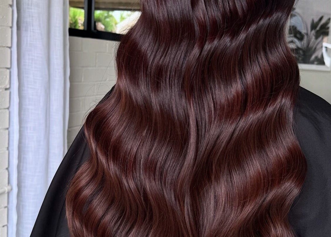 Glossy wavy hair styled at Colour Haus by TJ in Wilton, New South Wales, AU, showcasing expert salon work.