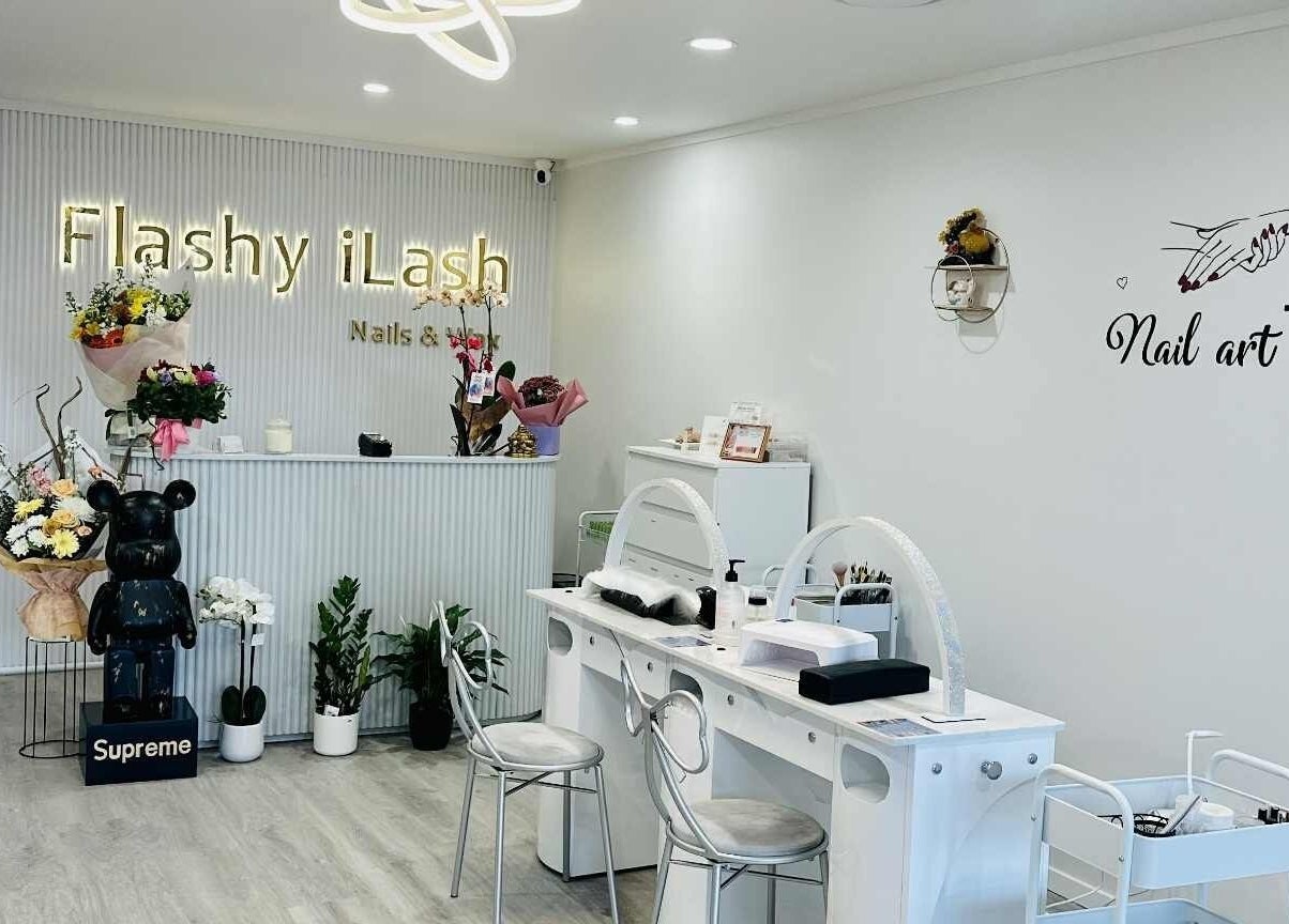 Interior of Flashy iLash, Auckland, NZ showing a stylish reception with nail art decor.