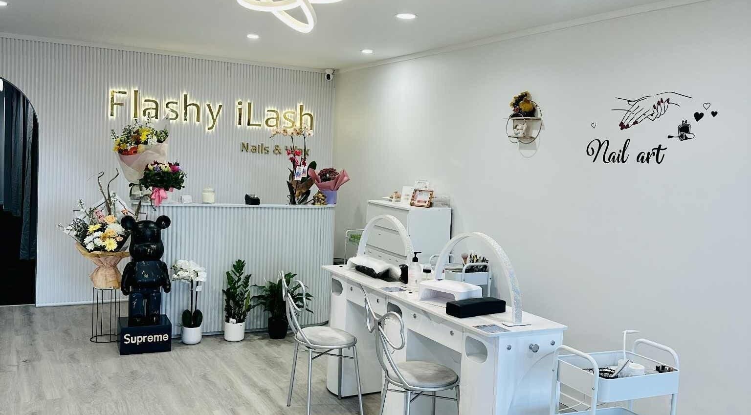 Interior of Flashy iLash, Auckland, NZ showing a stylish reception with nail art decor.