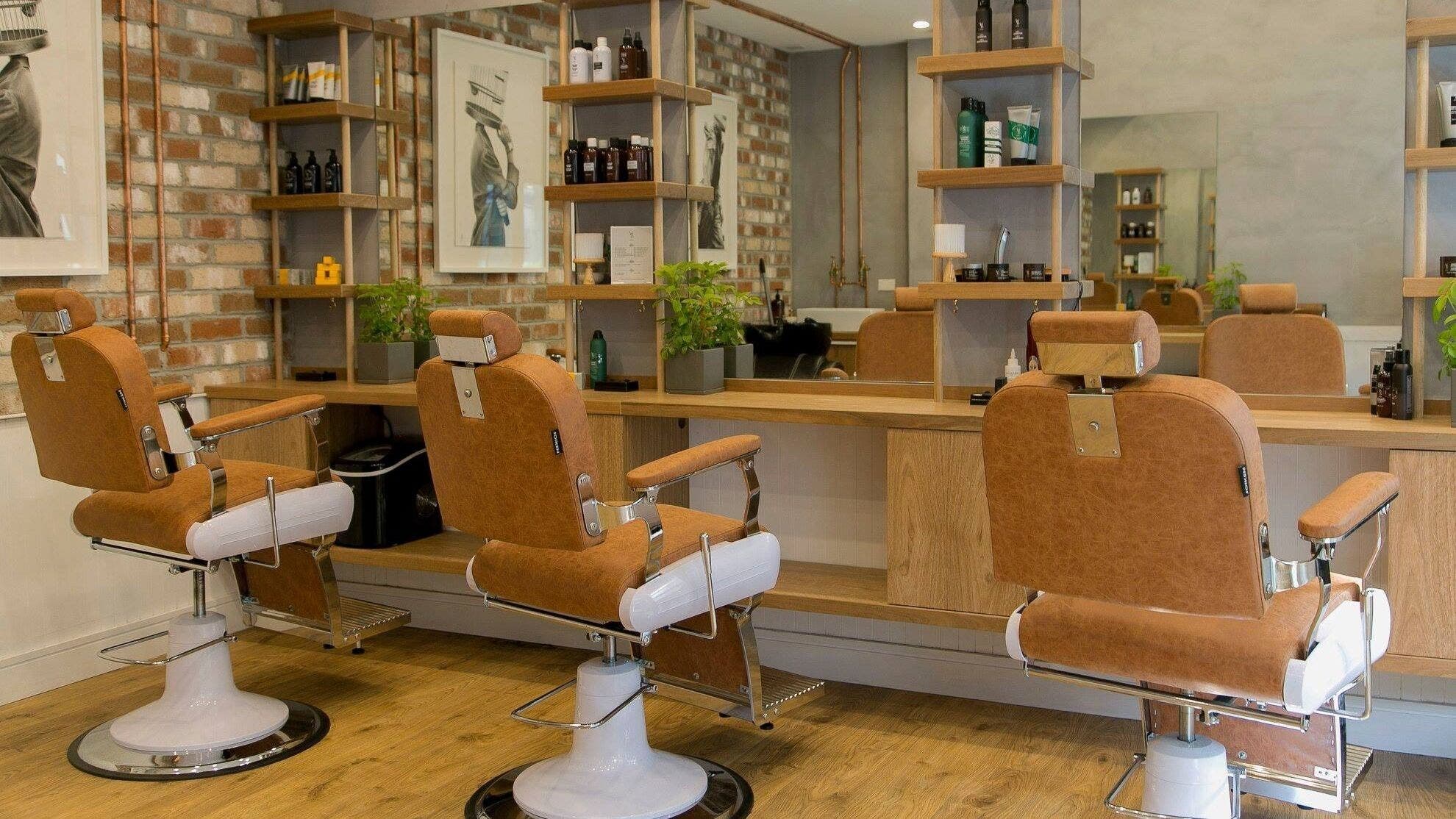 Chic interior of Adilla Barbers - Coogee, highlighting leather chairs and modern decor in Coogee, New South Wales, AU.