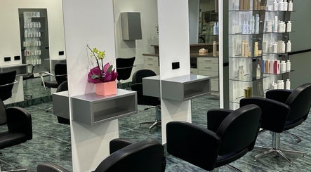 Modern salon interior at Dooki Hair & Co., Melbourne, Victoria, AU showcasing sleek black chairs and hair products.