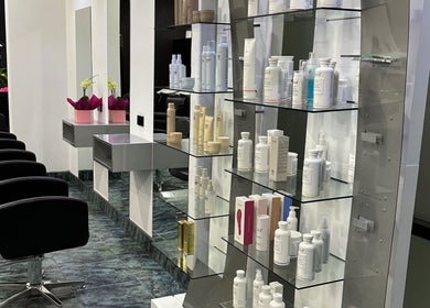 Sleek modern design at Dooki Hair & Co., Melbourne, Victoria, AU featuring salon chairs and beauty products.