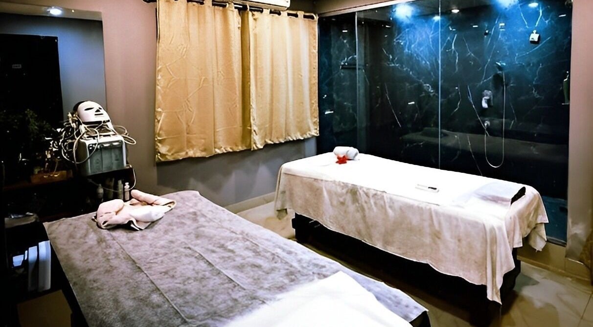 Ajna Spa massage room in Bengaluru, Karnataka, IN featuring two therapy beds and a serene ambiance.
