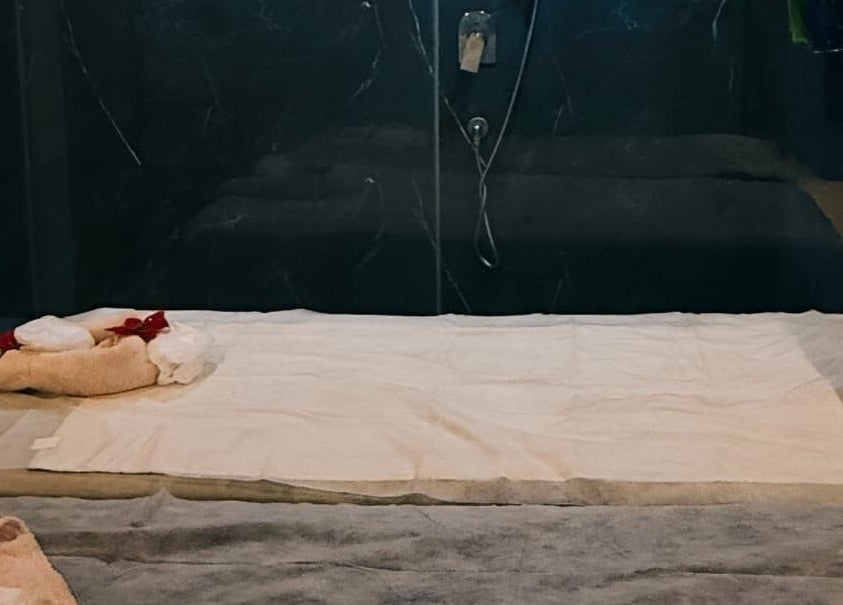 Relaxing massage room at Ajna Spa in Bengaluru, Karnataka, IN, featuring a neatly arranged towel.