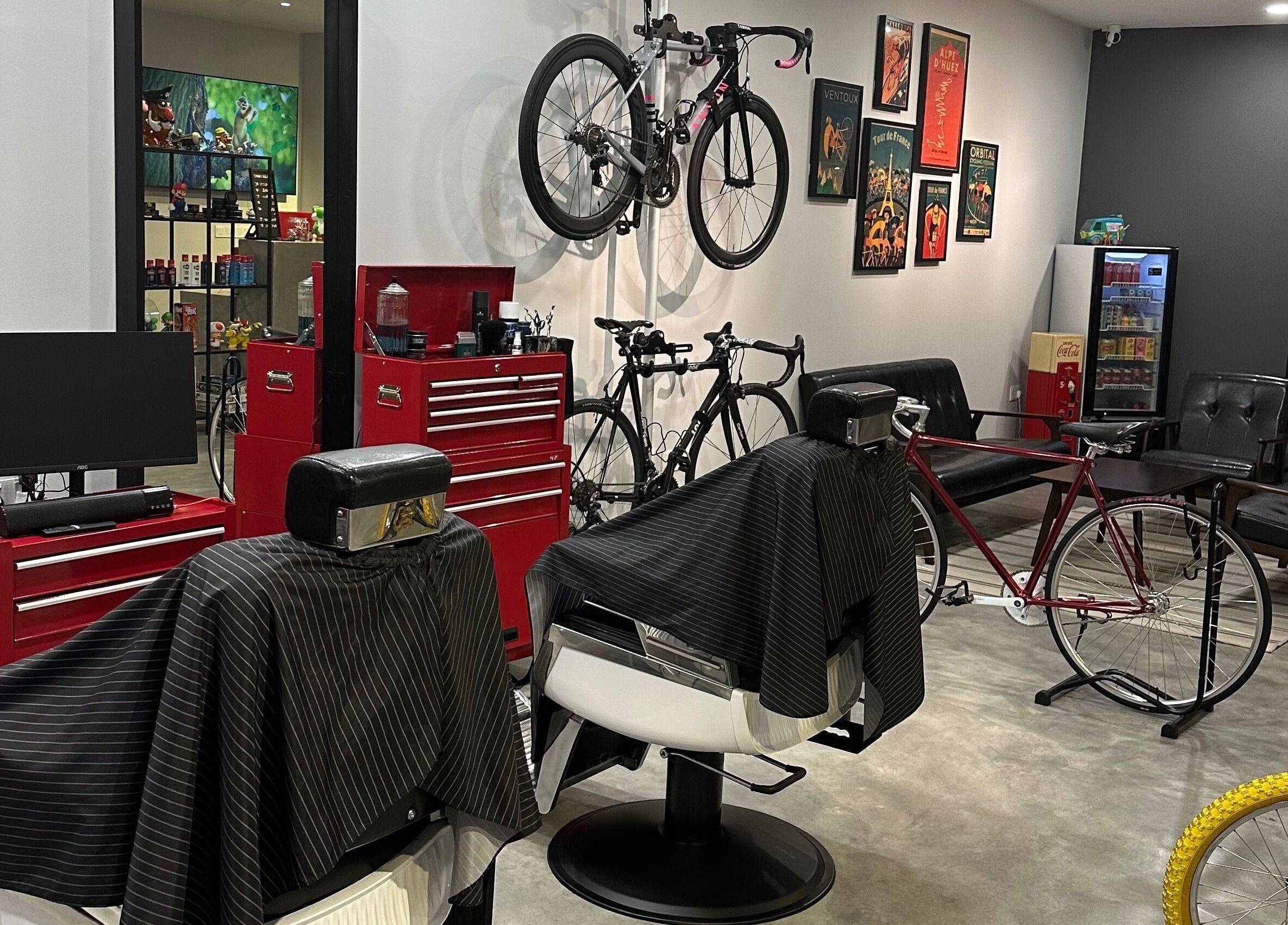 Interior of Pedal Barbers in Shah Alam, Selangor, MY, featuring barber chairs and bicycles on display.