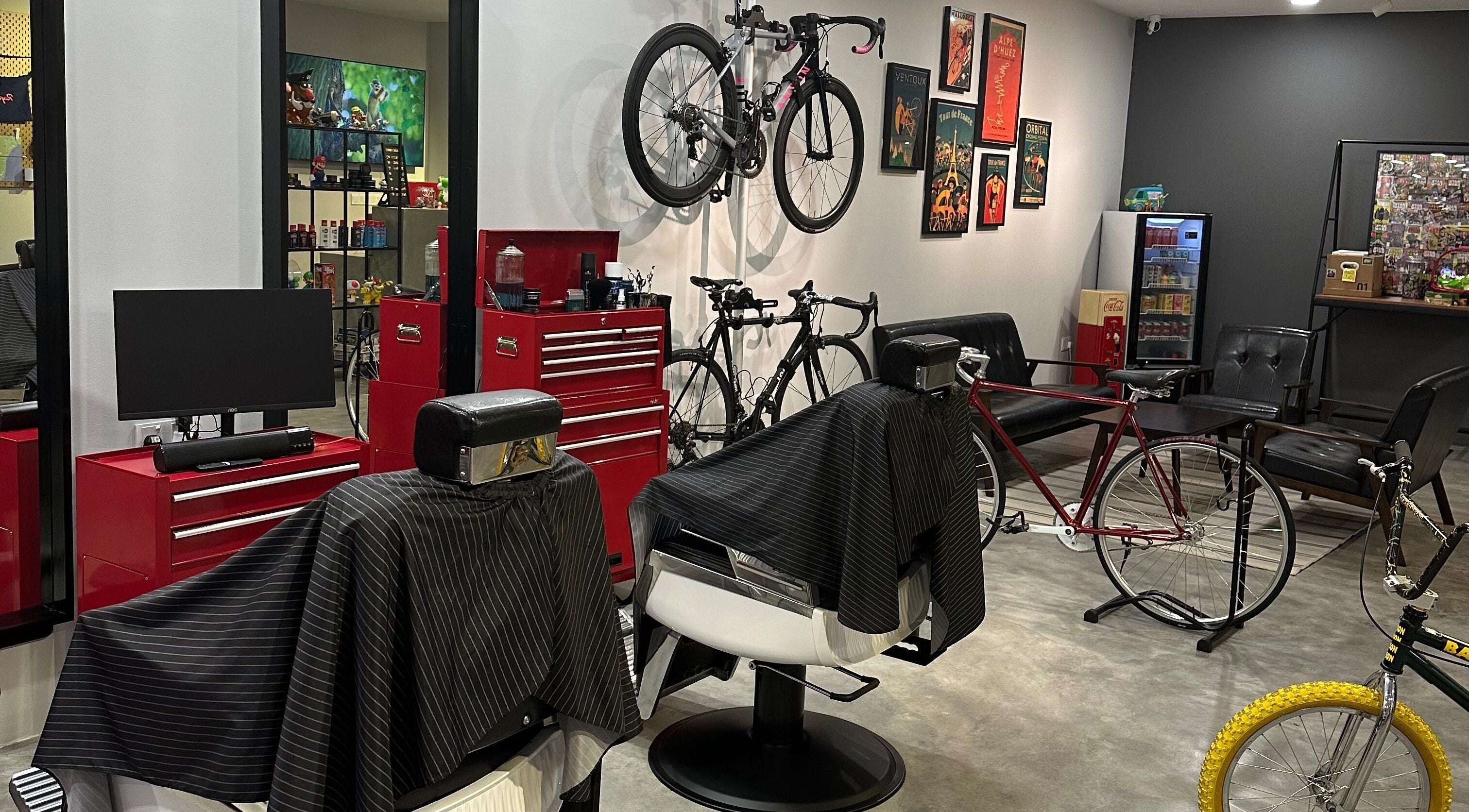 Interior of Pedal Barbers in Shah Alam, Selangor, MY, featuring barber chairs and bicycles on display.