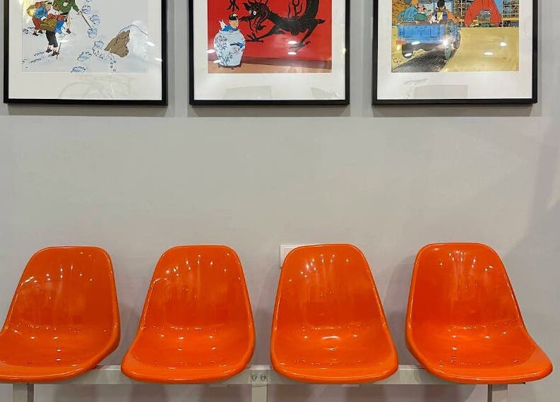 Bright orange chairs in the waiting area of Pedal Barbers, Shah Alam, Selangor, MY showcasing modern art.