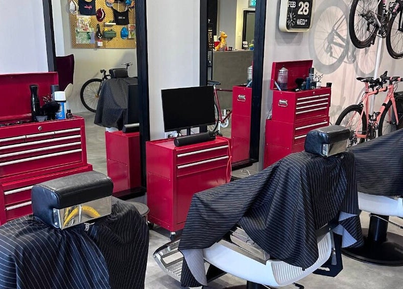 Modern interior of Pedal Barbers in Shah Alam, Selangor, MY, featuring stylish barber chairs and bicycles.