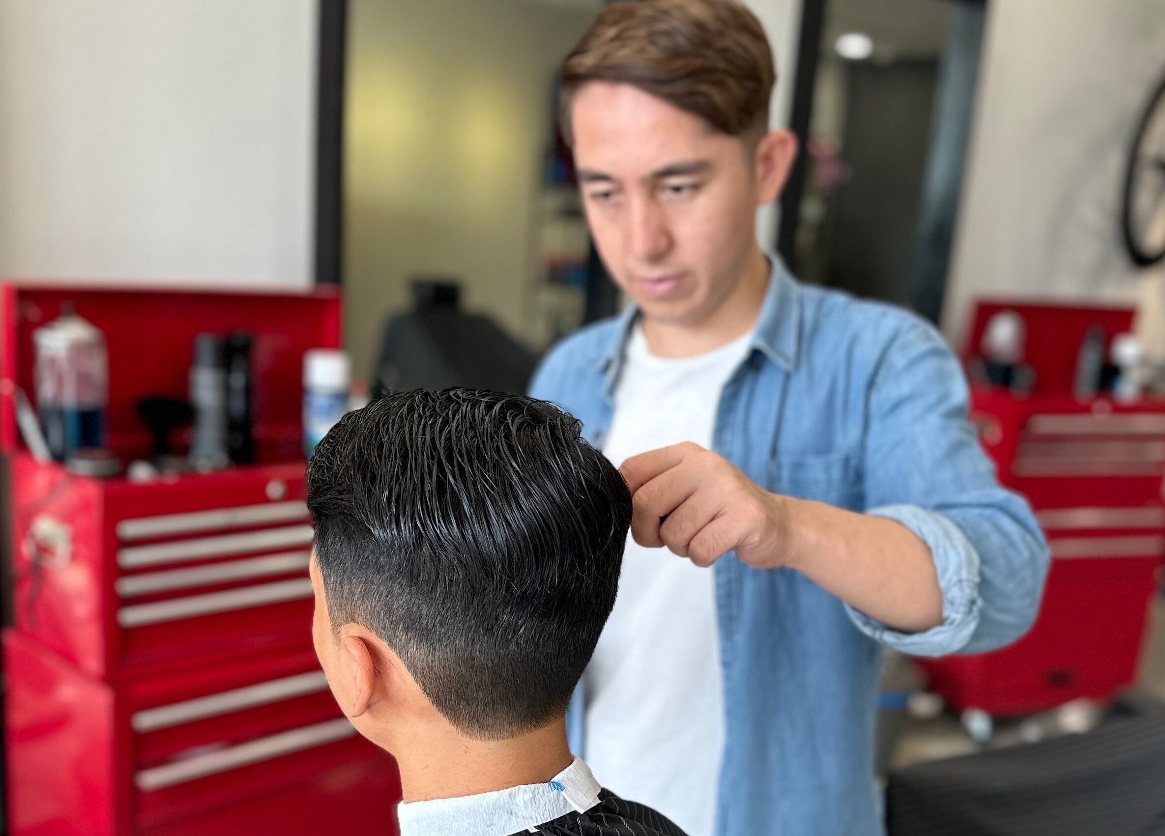 Expert barber styling hair at Pedal Barbers in Shah Alam, Selangor, MY with precision and care.