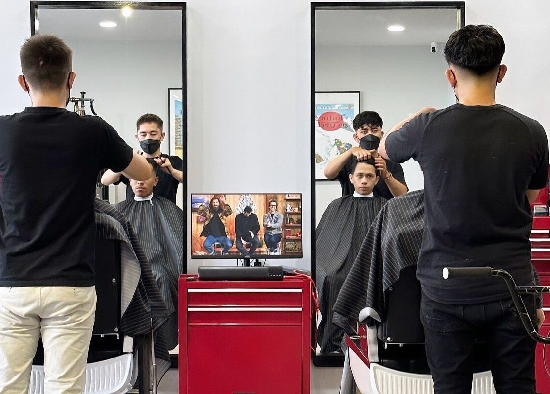 Stylists at Pedal Barbers in Shah Alam, Selangor, MY, expertly cutting hair in a modern setting.