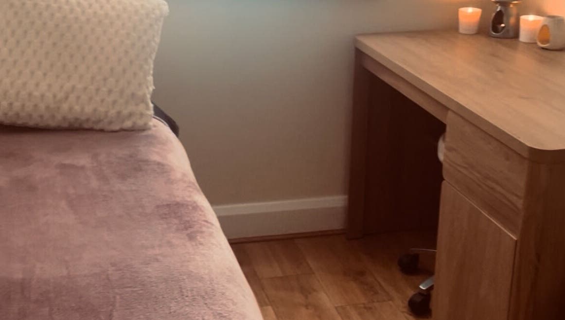 Relaxing therapy room at Kilkenny Acupuncture Clinic, Kilkenny, County Kilkenny, IE with a cozy bed and candles.