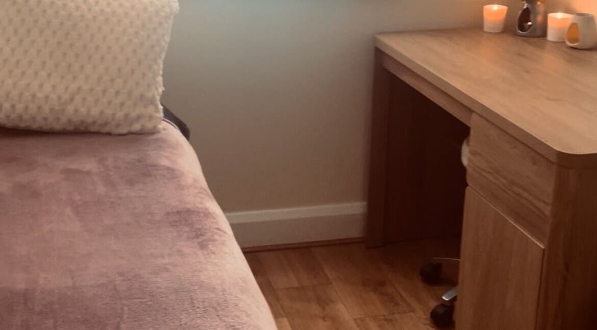 Relaxing therapy room at Kilkenny Acupuncture Clinic, Kilkenny, County Kilkenny, IE with a cozy bed and candles.