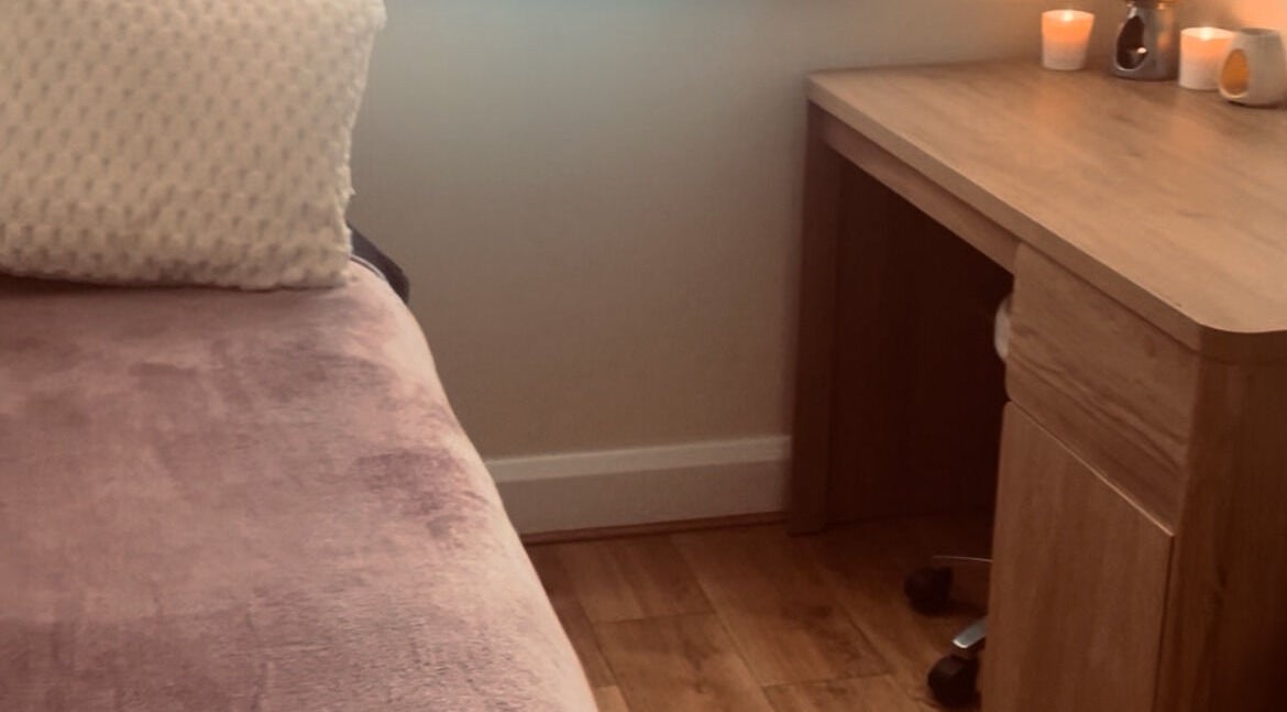 Relaxing therapy room at Kilkenny Acupuncture Clinic, Kilkenny, County Kilkenny, IE with a cozy bed and candles.